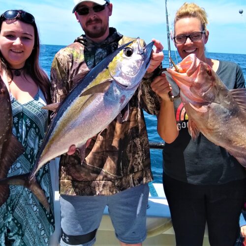 Brooks Family from Boise, Idaho showing part of their killer catch from the HUB private fishing charter with Capt Garett Hubbard red grouper on either side with Blackfin tuna in the middle